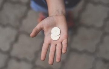 Person with coins in their hand